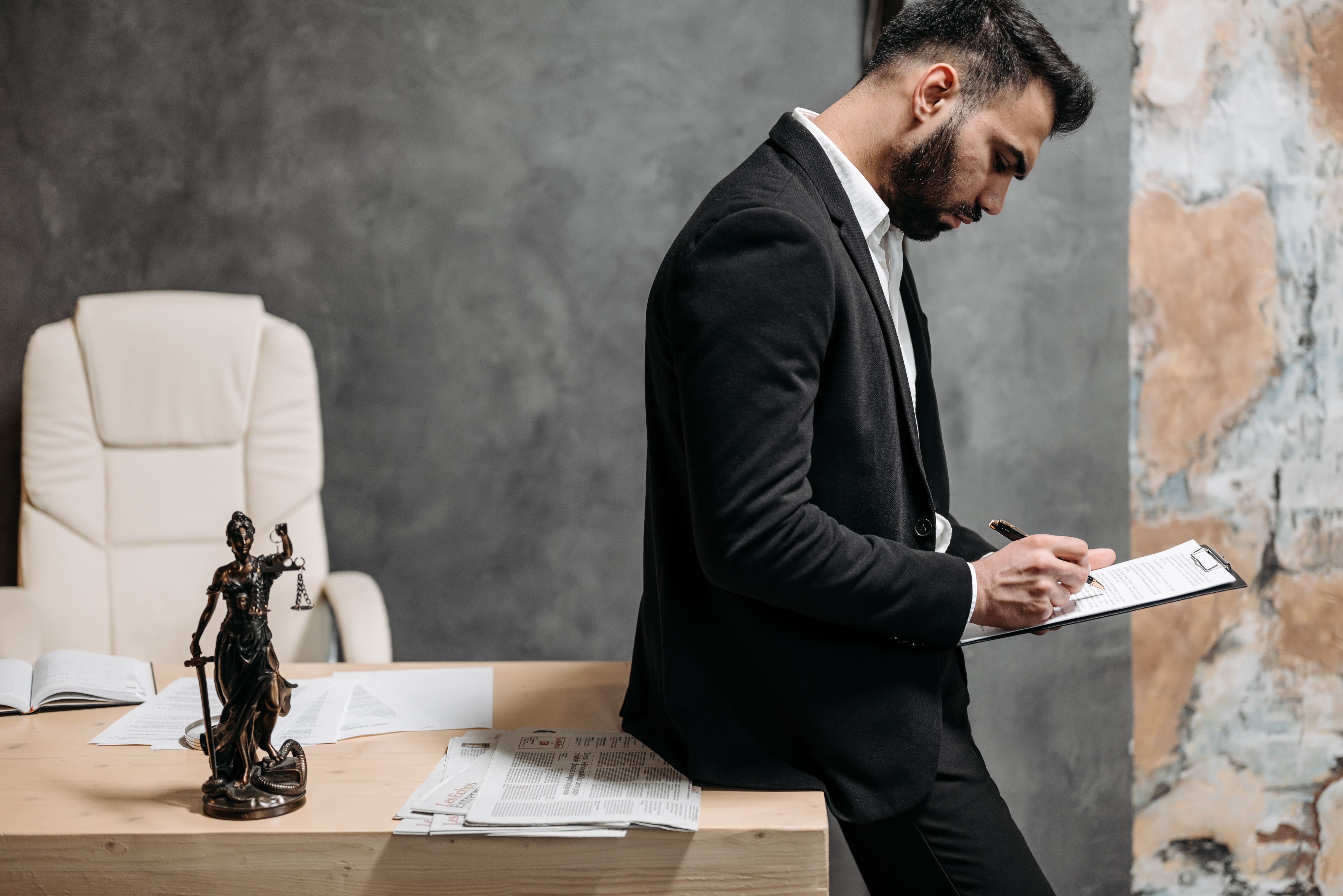 Lawyer reviewing paperwork at an office desk