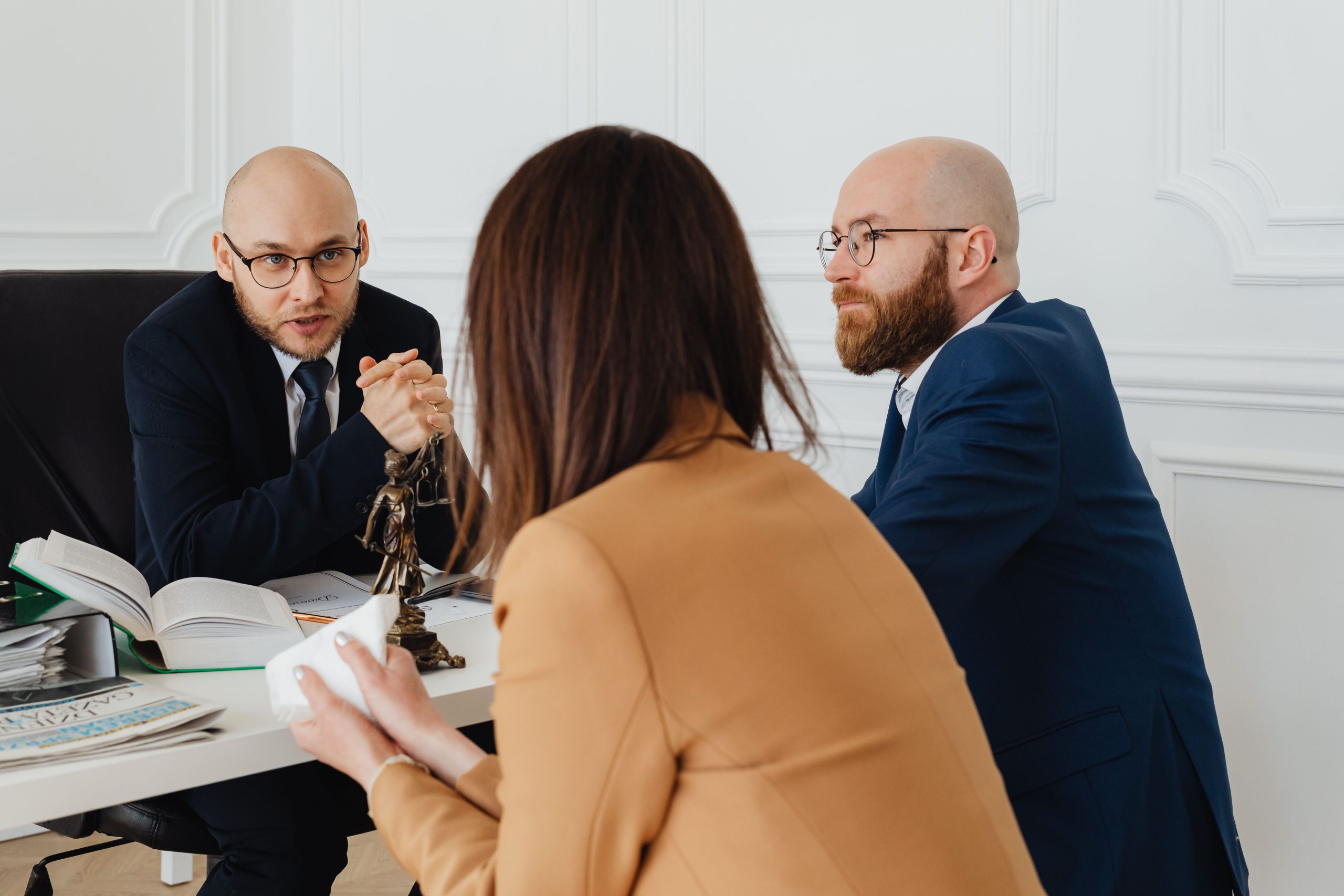 Group litigation lawyers discussing a shared case in a modern office