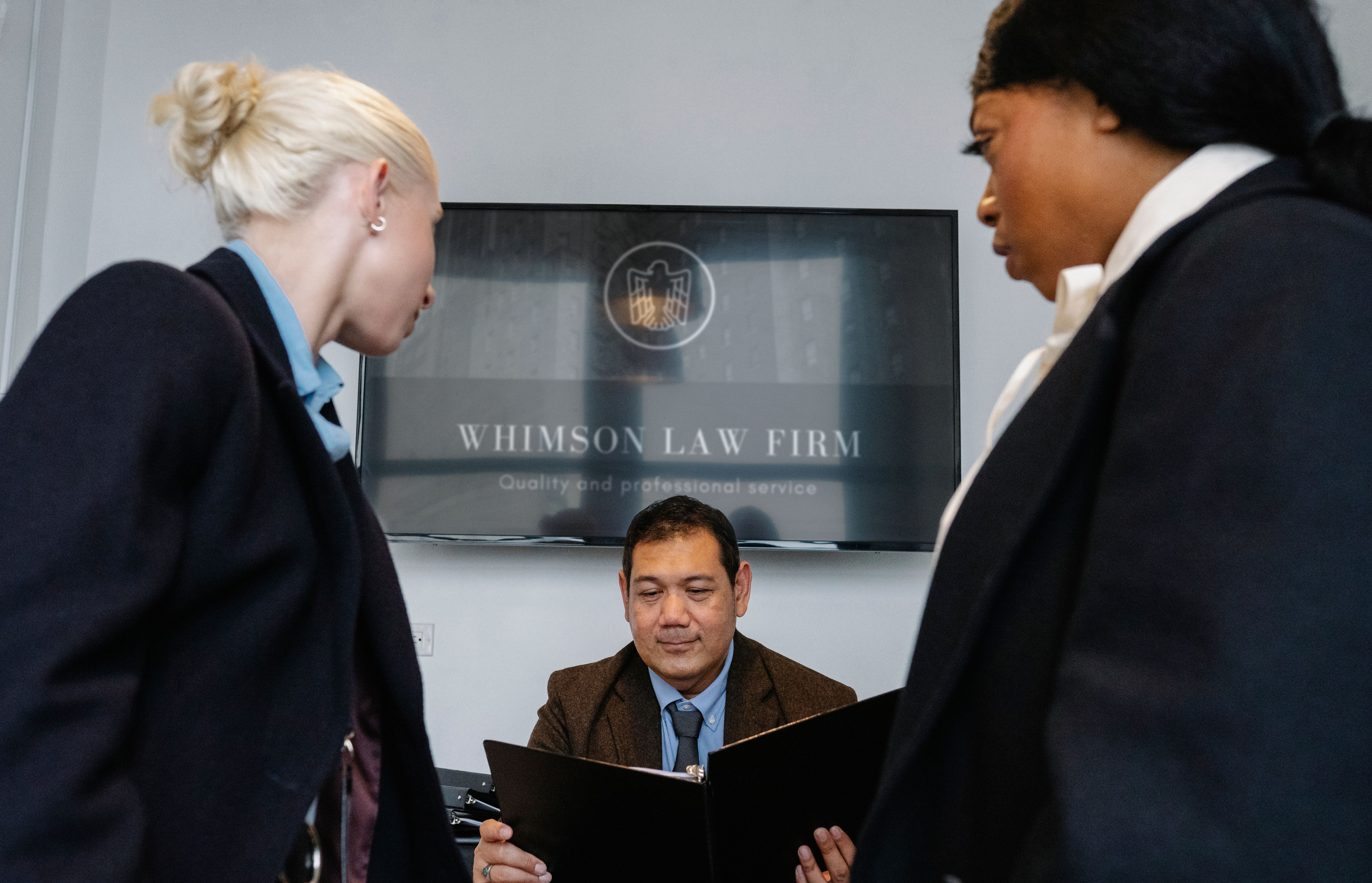 Legal team reviewing group litigation claim documents at a conference table