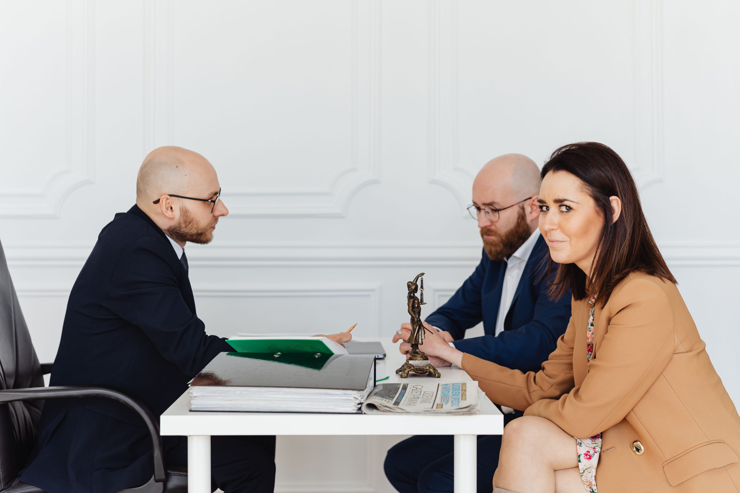 Lawyer consulting with clients in an office about an ongoing legal matter